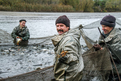 Men in river