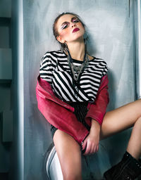 Portrait of beautiful young woman sitting at home