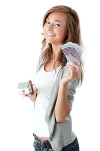 Portrait of smiling young woman using phone against white background