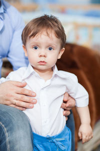 Midsection of father with cute son at home