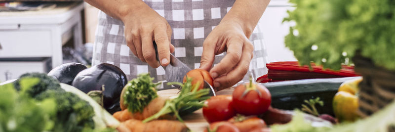 Male chef cutting vegetable on kitchen counter