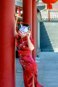 Midsection of woman standing in city