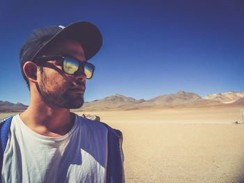 Portrait of man on in desert against sky