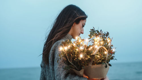 Girl on the beach with a bag of lights