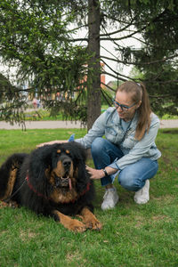 Young woman with dog on field