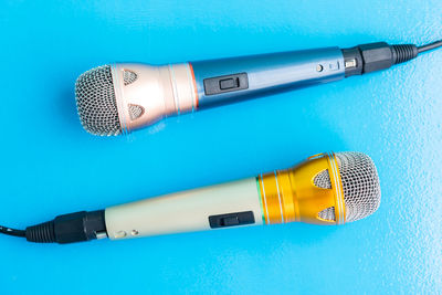 Close-up of microphones on blue background