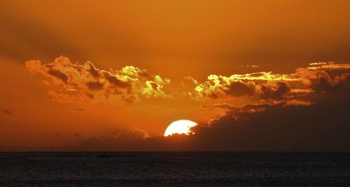 Scenic view of sea against orange sky