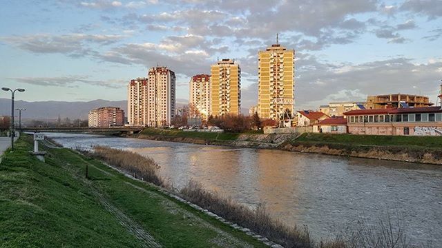 building exterior, architecture, built structure, water, sky, city, cloud - sky, river, reflection, cloud, cityscape, residential building, building, residential structure, grass, canal, waterfront, tower, cloudy, skyscraper