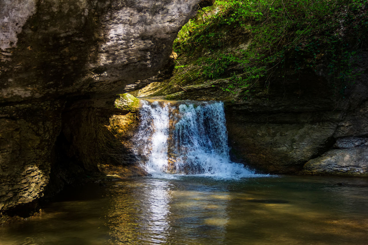 water, nature, waterfall, rock, beauty in nature, motion, scenics - nature, river, rock formation, water feature, body of water, no people, flowing water, land, tree, reflection, long exposure, plant, outdoors, formation, environment, cave, forest, day, non-urban scene, stream, flowing, waterfront, sea cave, cliff, autumn, blurred motion, splashing, travel destinations, tranquility, power in nature