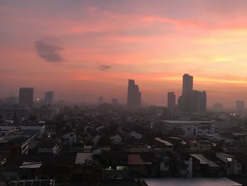 Cityscape against sky during sunset