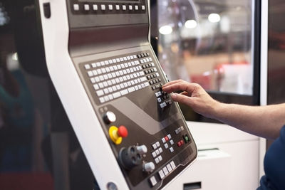 Close-up of hand using atm machine