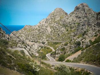 High angle view of road leading towards mountains against sky