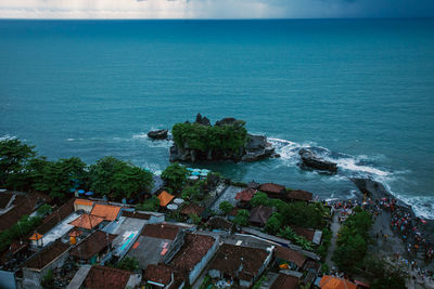 High angle view of sea and buildings against sky