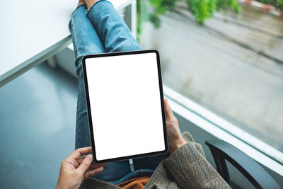 Top view mockup image of a business woman holding digital tablet with blank white desktop screen