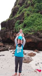 Portrait of happy boy standing on rock