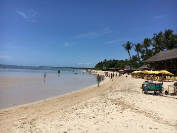 Scenic view of beach against blue sky