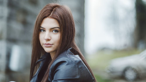 Portrait of young woman wearing leather jacket