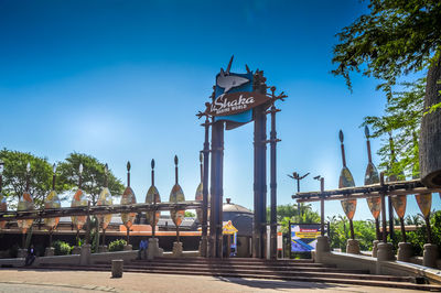 View of bridge and building against blue sky