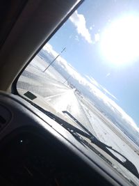 Reflection of clouds in sky seen through glass window