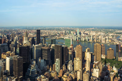 Aerial view of modern buildings in city against sky