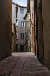 Empty alley amidst buildings in town