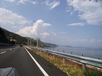 Road by sea against sky