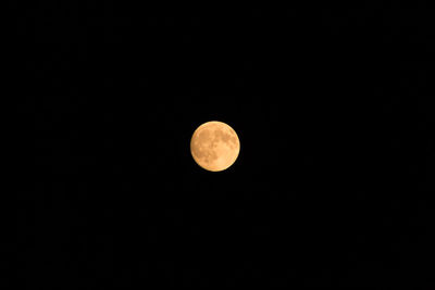 Low angle view of moon against clear sky at night