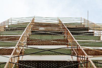 Low angle view of metallic structure against sky