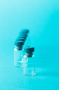 Close-up of glass bottle against blue background