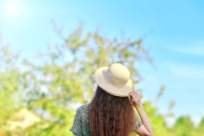 Rear view of woman wearing hat against sky