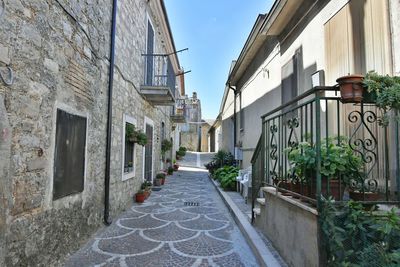 A narrow street among the old houses of greci, a village in the campania region, italy.