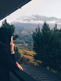 Woman wearing hijab standing in balcony