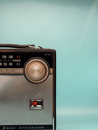 Close-up of vintage radio against blue background