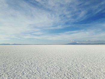 Scenic view of salar de uyuni against blue sky