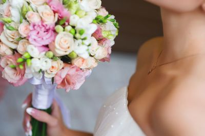 Midsection of woman holding flower bouquet