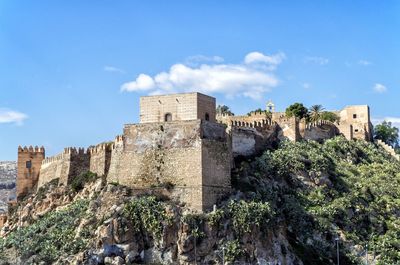 Low angle view of historic building against sky, alcazaba of almería, spain