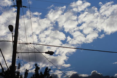 Low angle view of electricity pylon against sky