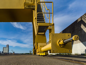 Low angle view of yellow construction site against sky