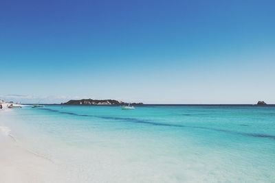 View of beach against blue sky