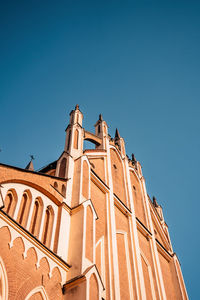 Low angle view of building against clear blue sky