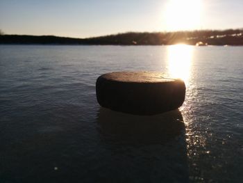 Close-up of sea against sky during sunset