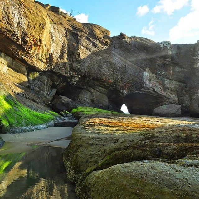 rock formation, rock - object, mountain, sky, rock, water, cliff, nature, rocky mountains, tranquility, sunlight, tranquil scene, scenics, beauty in nature, day, outdoors, rocky, geology, cloud, no people