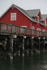 Building by river against sky