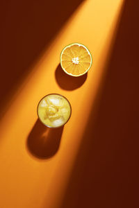 High angle view of orange by drink on table