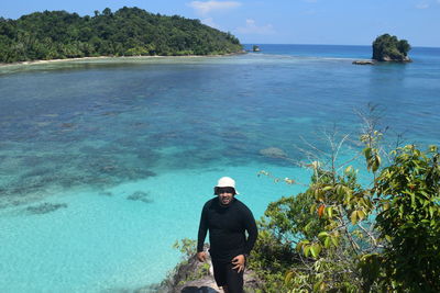 Man standing by sea against sky