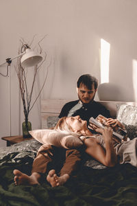 Couple relaxing on bed at home