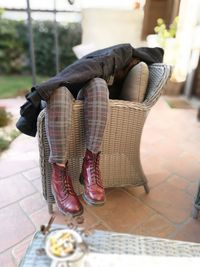 Low section of woman sitting on chair