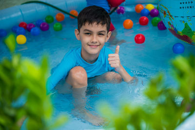 Portrait of smiling boy in swimming pool