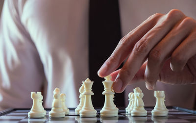 Close-up of man playing with chess