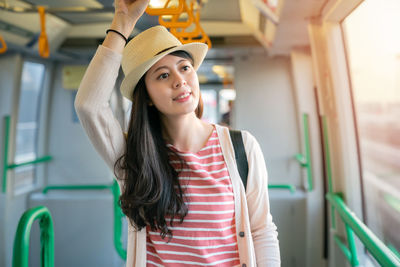 Portrait of beautiful young woman in hat looking away